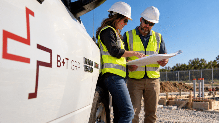 Infrastructure Construction Management B+T construction management team reviewing plans at an infrastructure construction site